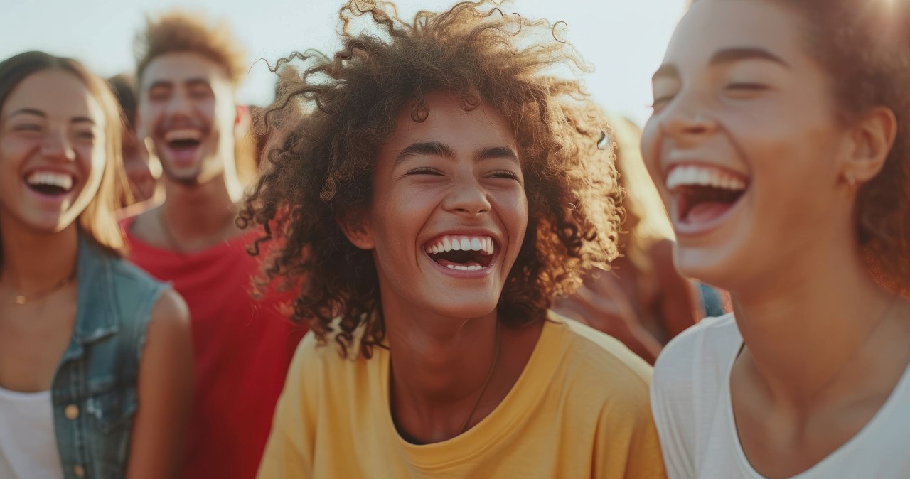 Friends laughing having fun outdoors enjoying a cheerful moment together
