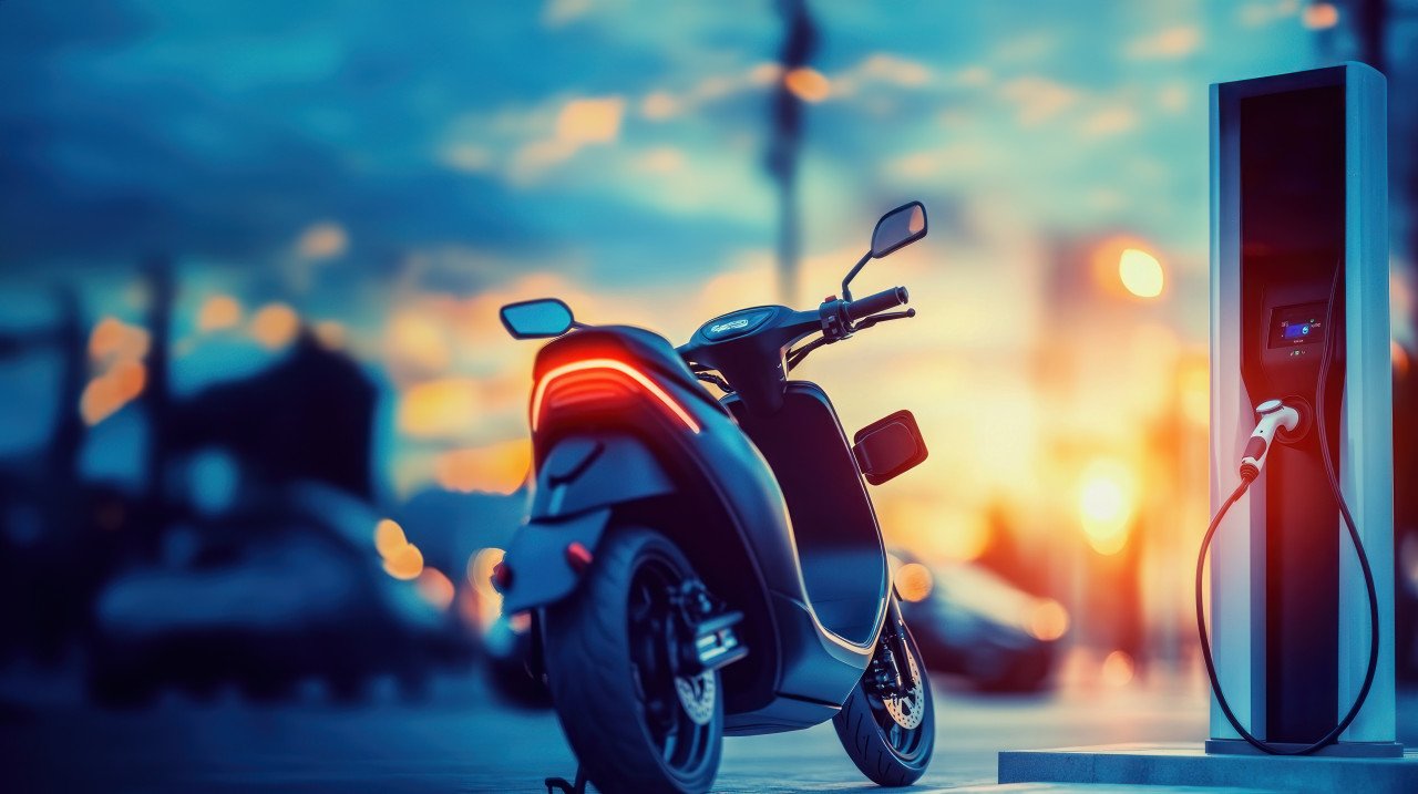 An electric scooter charging at a city station focus on charging port electric scooter