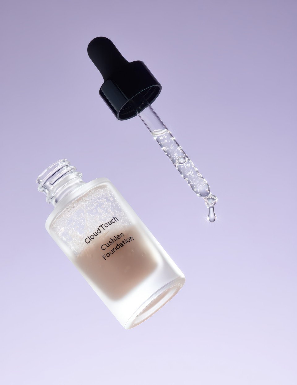 Glass serum foundation bottle with tiny bubbles and dropper dripping liquid under cool light on lavender background